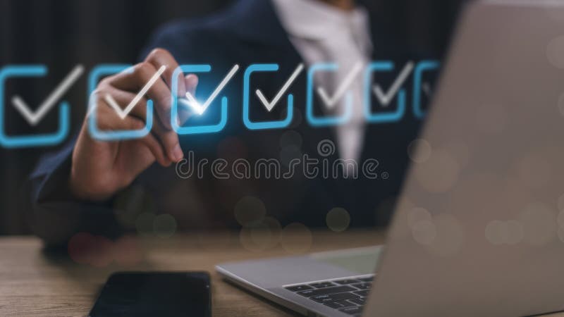 Checklist concept. Businessman using a laptop. Checking marks on checkboxes on the futuristic virtual interface screen royalty free stock images