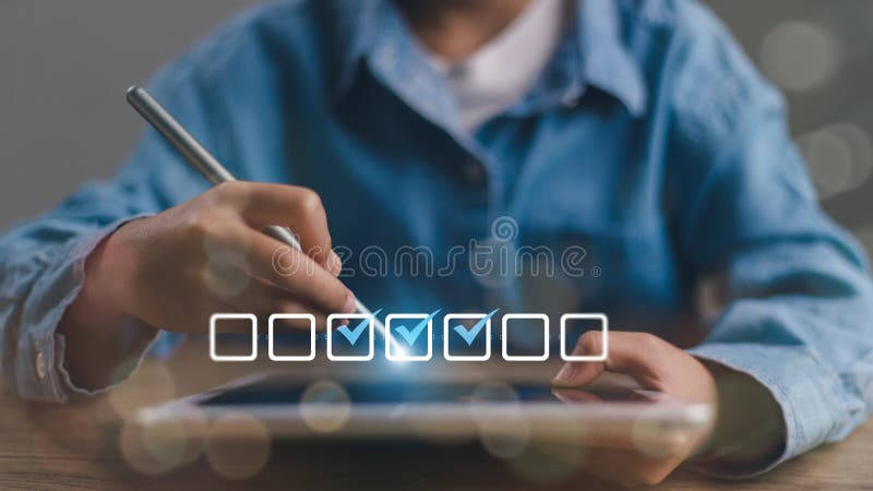 Checklist concept. Businessman using tablet. Checking marks on checkboxes on the futuristic virtual interface screen royalty free stock image