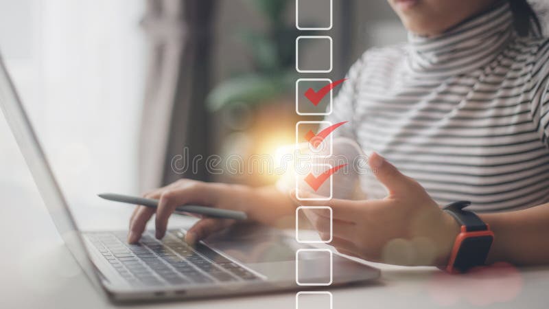 Checklist concept. Businesswoman using a laptop. Checking marks on checkboxes on the futuristic virtual interface screen royalty free stock photo