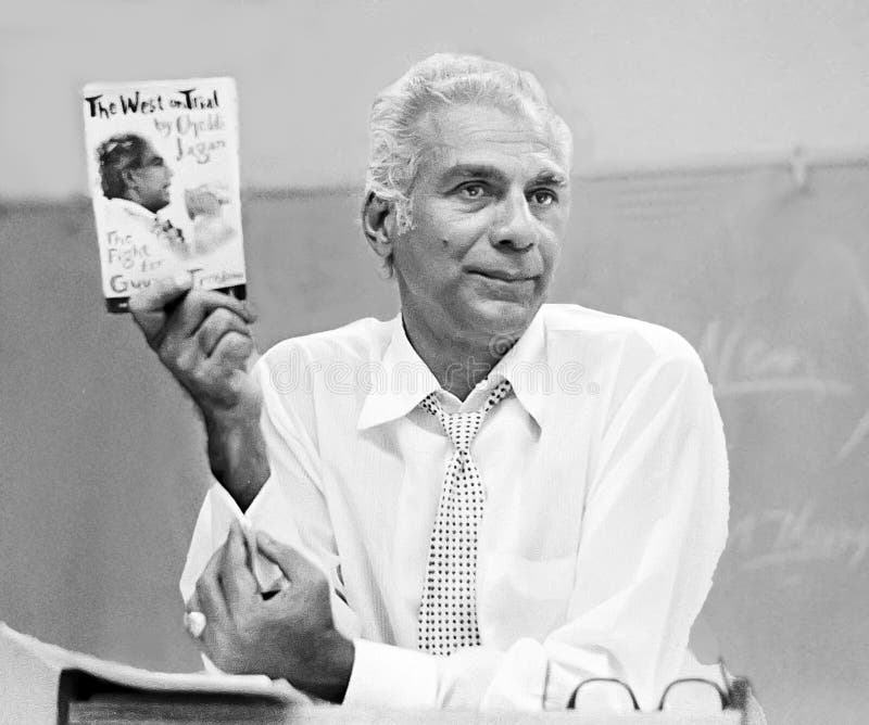 Cheddi Jagan, widely regarded as the father of the independent nation of Guyana in South America, holds up his book, `The West on Trial,` during a lecture in a half-filled classroom at the University of Southern California in 1975.  Jagan was feared by both Britain, the colonial ruler over British Guyana, and the United States as a Marxist and a possible stalking horse for Soviet Communism.  History has thrown these assumptions into doubt as Jagan was in reality a democratic socialist.  Jagan had strong ties to the United States spending decades in America, studying at Howard University and the Northwestern University School of Dentistry.  Jagan was deposed as prime minister and president in 1964 as his country suffered through a chaotic period of racial, economic, and political strife, with a newly-independent nation divided between a South Asian Indian population and an equal number of people of African descent, led by his rival, Forbes Burnham.  Jagan became a labor movement leader but again assumed leadership of the nation from 1992 until 1997 when a heart attack forced him to be evacuated to the United States for treatment.  He died on March 6, 1997 in Washington, DC, 2 weeks before turning 79.  Upon his death, his American-born and raised wife, Janet Rosenberg Jagan, assumed Guyana&#x27;s leadership and left office in 1999.  She died in 2009 in Georgetown, Guyana, at the age of 88. Cheddi Jagan, widely regarded as the father of the independent nation of Guyana in South America, holds up his book, `The West on Trial,` during a lecture in a half-filled classroom at the University of Southern California in 1975.  Jagan was feared by both Britain, the colonial ruler over British Guyana, and the United States as a Marxist and a possible stalking horse for Soviet Communism.  History has thrown these assumptions into doubt as Jagan was in reality a democratic socialist.  Jagan had strong ties to the United States spending decades in America, studying at Howard University and the Northwestern University School of Dentistry.  Jagan was deposed as prime minister and president in 1964 as his country suffered through a chaotic period of racial, economic, and political strife, with a newly-independent nation divided between a South Asian Indian population and an equal number of people of African descent, led by his rival, Forbes Burnham.  Jagan became a labor movement leader but again assumed leadership of the nation from 1992 until 1997 when a heart attack forced him to be evacuated to the United States for treatment.  He died on March 6, 1997 in Washington, DC, 2 weeks before turning 79.  Upon his death, his American-born and raised wife, Janet Rosenberg Jagan, assumed Guyana&#x27;s leadership and left office in 1999.  She died in 2009 in Georgetown, Guyana, at the age of 88.
