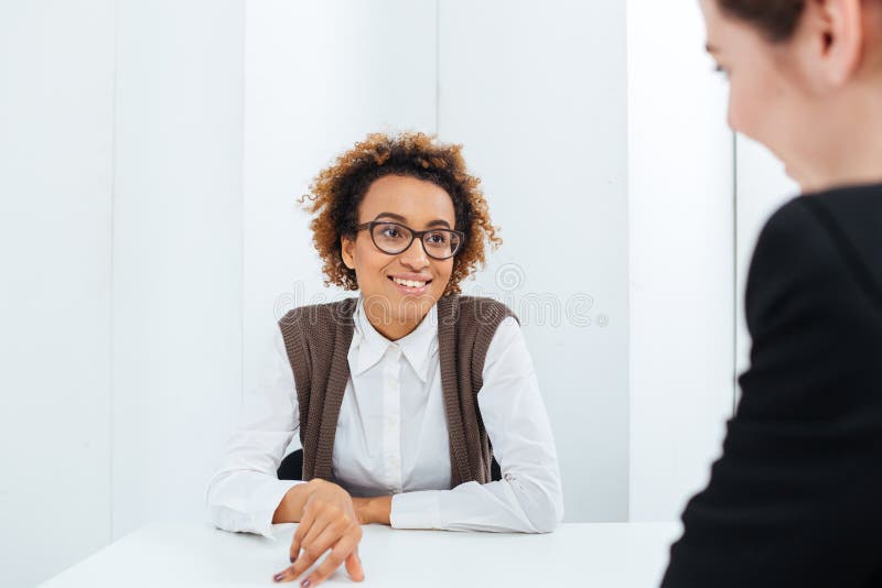 Cheerful african american businesswoman interviewing candidate for new position
