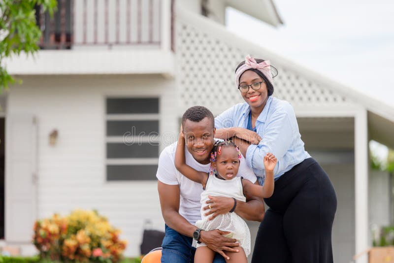 Cheerful african american family with luggage into new home, Happiness family concepts