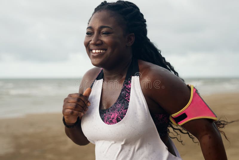 Cheerful african runner jogging during outdoor workout on beach royalty free stock photo Cheerful african runner jogging during outdoor workout on beach royalty free stock photo