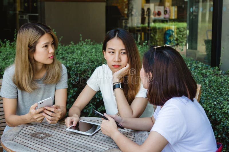 Cheerful Asian Young Women Sitting In Cafe Drinking Coffee With Friends