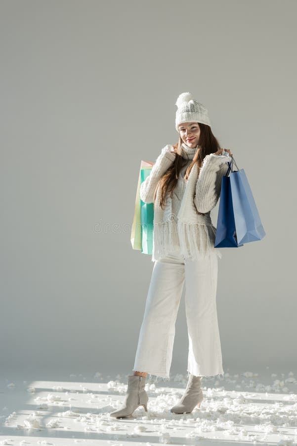 cheerful attractive woman in stylish winter sweater and scarf standing with shopping bags stock image cheerful attractive woman in stylish winter sweater and scarf standing with shopping bags stock image