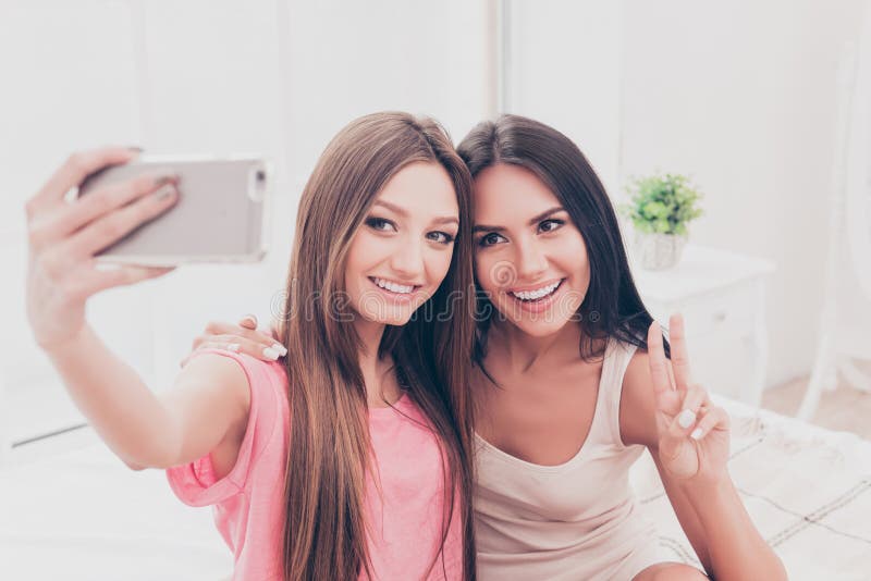 Cheerful Attractive Women in Pajamas Making Selfie in Bedroom Stock ...