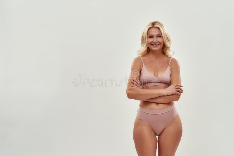 Mature woman posing in panties Cheerful Beautiful Middle Aged Woman Wearing Lingerie Keeping Arms Crossed Smiling At Camera While Posing Isolated Over Stock Photo Image Of Hygiene Procedure 208823816