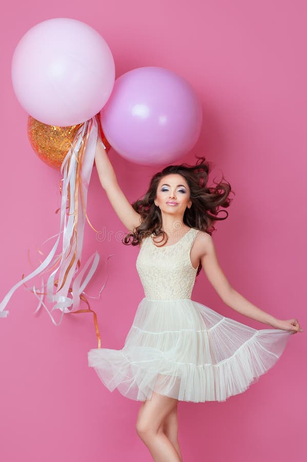 cheerful beautiful young girl dress sparkle pink helium balloons enjoying birthday photoshoot dancing smiling p 111876520
