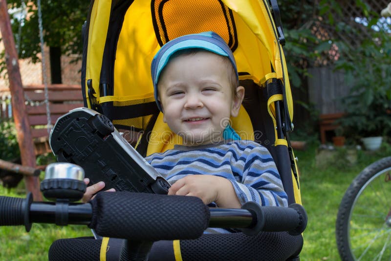 Cheerful boy on a tricycle stock image. Image of family 93333285
