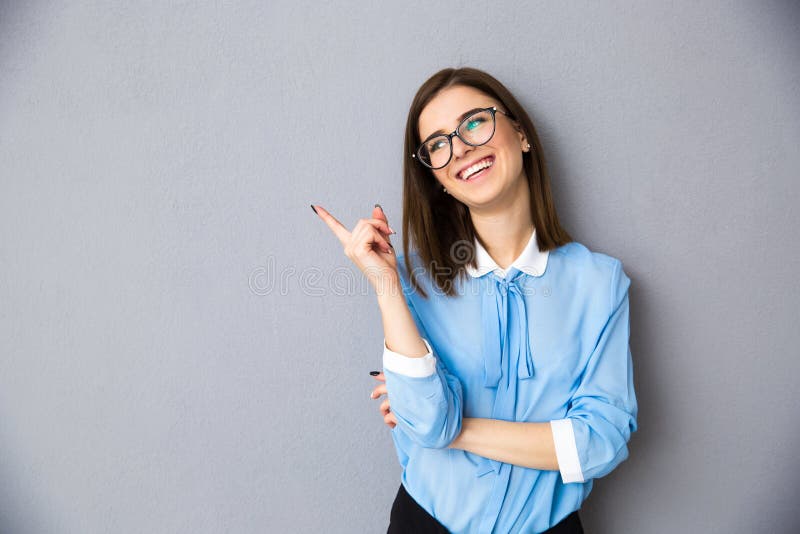 Cheerful businesswoman in glasses pointing away royalty free stock photos Cheerful businesswoman in glasses pointing away royalty free stock photos
