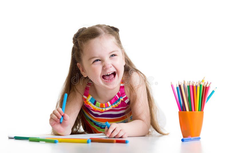 Cheerful child girl drawing with pencils in