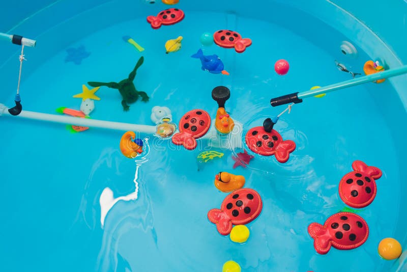 Fishing in the Paddling Pool. Children S Toys in the Pool. Toy Fish Fishing  Rod Stock Photo - Image of cute, looking: 266544246