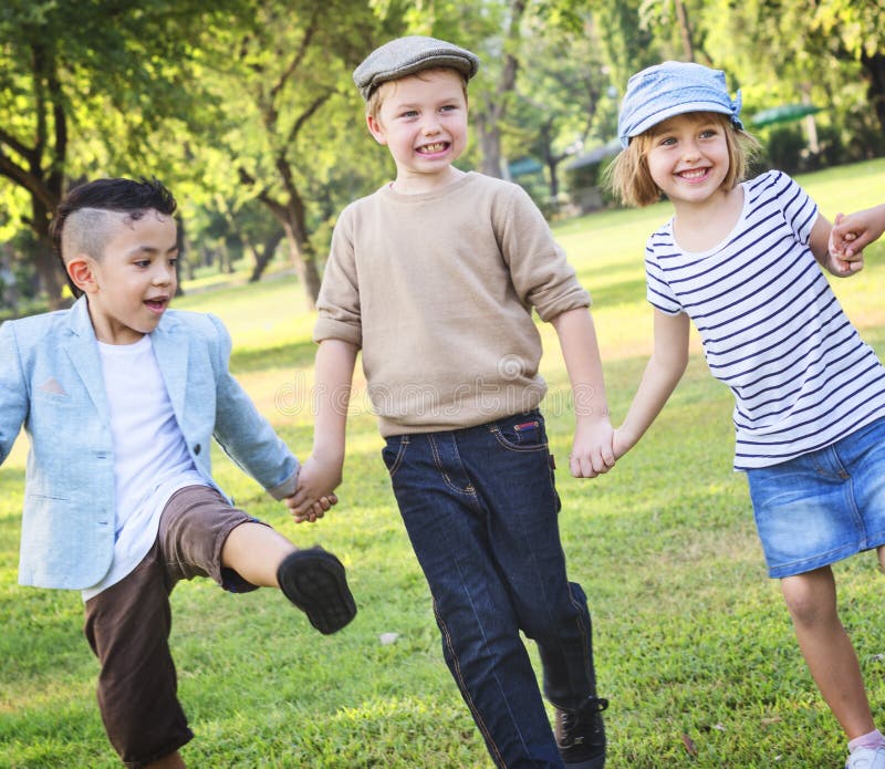 Cheerful Children Holding Hands in the Park Stock Image - Image of ...