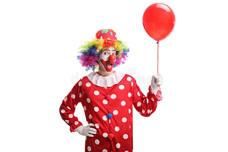 Cheerful clown holding a red balloon stock images