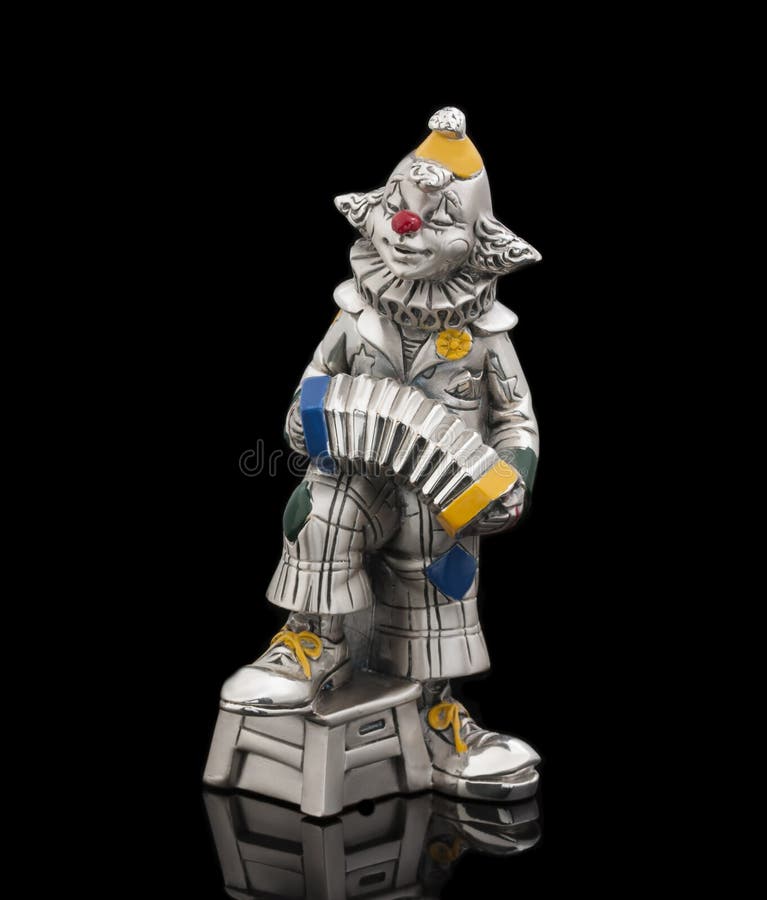 A cheerful clown plays the accordion stock images