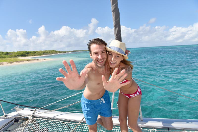 Cheerful couple on the deck of sailing boat in caribbean sea royalty free stock image Cheerful couple on the deck of sailing boat in caribbean sea royalty free stock image