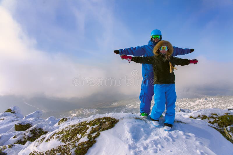 Cheerful couple snowboarders standing on the mountain and enjoyed recreation stock photos