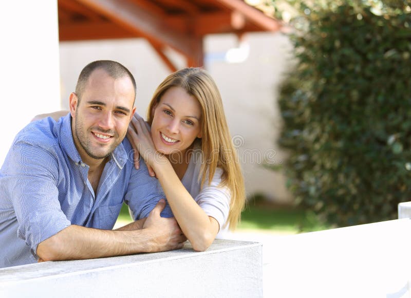 Cheerful couple standing in the yard stock photo Cheerful couple standing in the yard stock photo