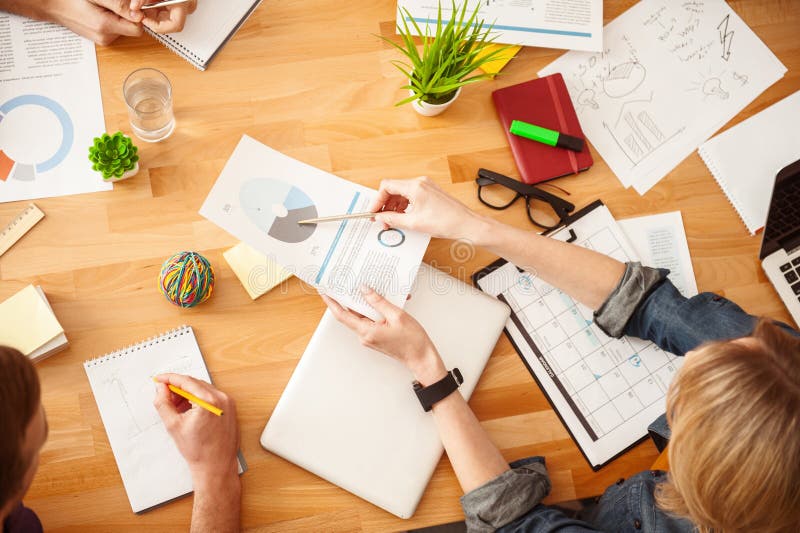 Cheerful creative team is doing paperwork stock photography Cheerful creative team is doing paperwork stock photography