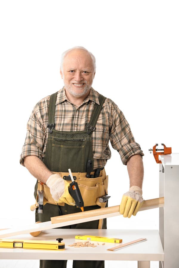 Cheerful elderly man tinkering stock photo Cheerful elderly man tinkering stock photo