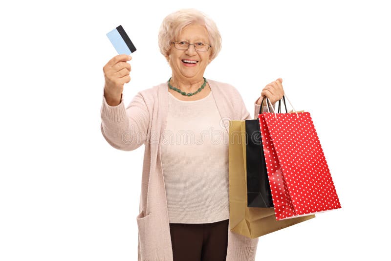 Cheerful elderly woman with a credit card and shopping bags