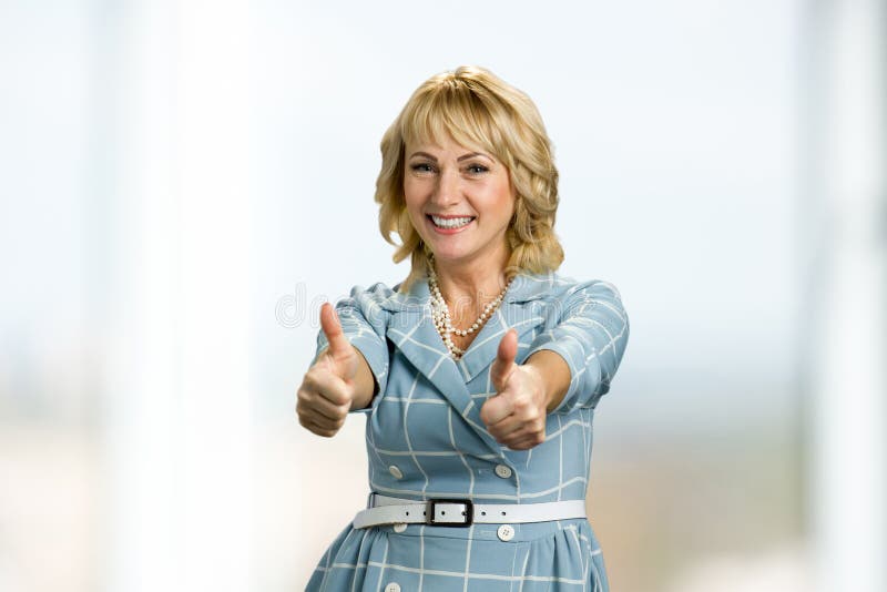 Cheerful elderly woman showing thumbs up sign. stock image Cheerful elderly woman showing thumbs up sign. stock image