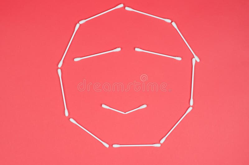 Cheerful Emoticon Made from Cotton Swabs on a Pink Background Stock