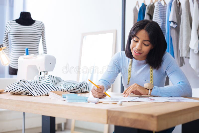 Cheerful Employee of an Atelier Smiling while Working Alone Stock Photo ...