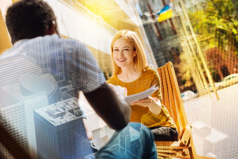 Cheerful employer looking glad while having a job interview stock image Cheerful employer looking glad while having a job interview stock image