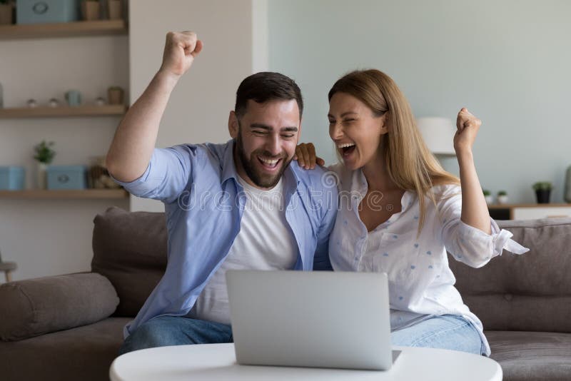 Cheerful Excited Millennial Husband and Wife Making Winner Yes Ha photo photo