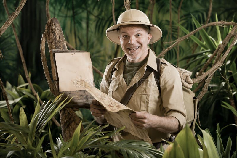 Cheerful vintage explorer in the jungle with map and blank sign. Adventurer adventure stock images, royalty-free photos and pictures
