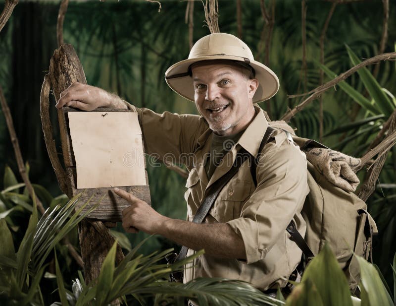 Cheerful explorer pointing to a sign looking at camera. Adventurer adventure stock images, royalty-free photos and pictures