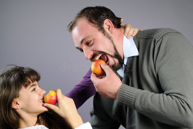 Cheerful family eating healthy fruits