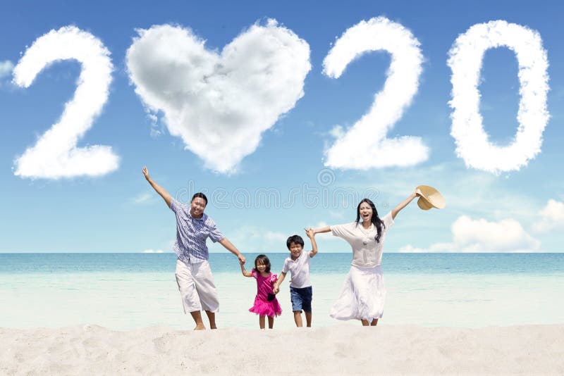 Cheerful family with number 2020 on beach stock photos Cheerful family with number 2020 on beach stock photos
