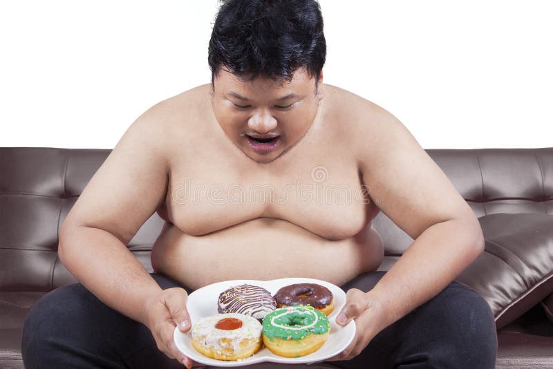 Cheerful fat man eating donuts.