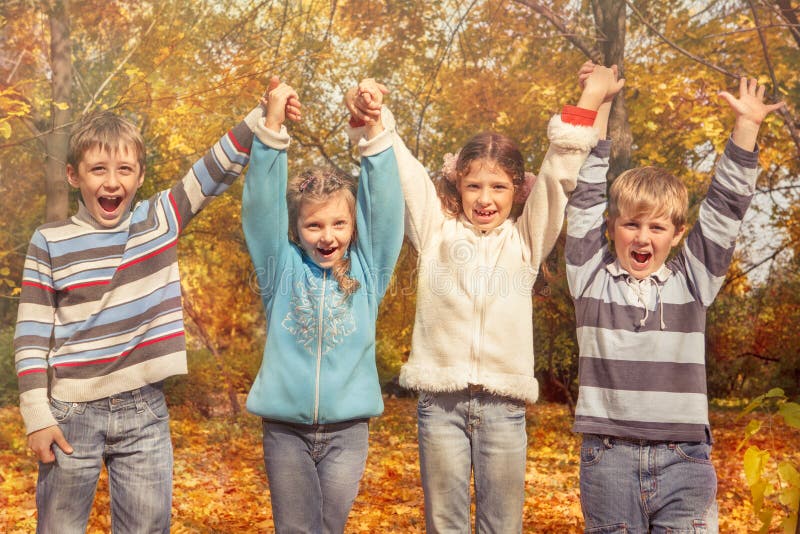 Cheerful friends holding hands royalty free stock images