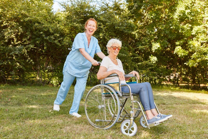 Nurse pushing wheelchair stock photo. Image of help, geriatric - 29235772