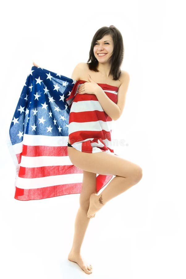 Cheerful girl wrapped into the American flag