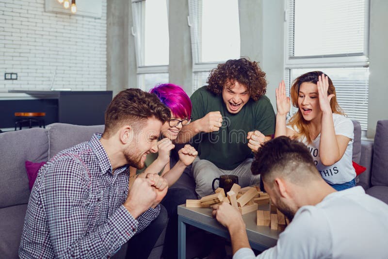 A group of friends play board games in the room Stock Photo - Alamy