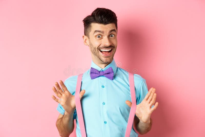 Cheerful Guy In Bow Tie Showing His Suspenders And Smiling Happy Feeling Upbeat Standing 