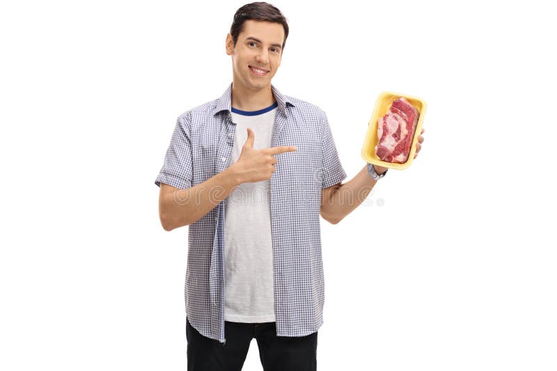Cheerful guy holding a steak and pointing royalty free stock image Cheerful guy holding a steak and pointing royalty free stock image
