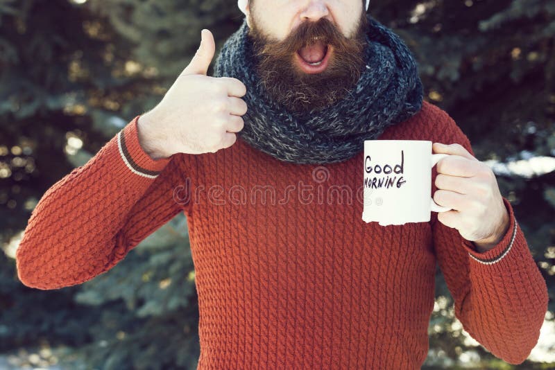 Cheerful handsome man, bearded hipster with beard and moustache gives thumbs up hand gesture with good morning text on royalty free stock photography Cheerful handsome man, bearded hipster with beard and moustache gives thumbs up hand gesture with good morning text on royalty free stock photography