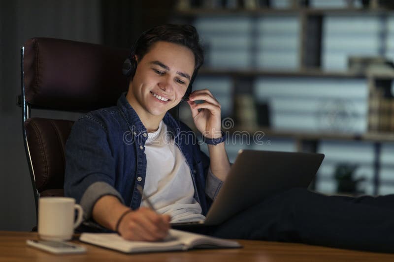 Cheerful Young Man Employee Working Night Shift at Office Stock Image