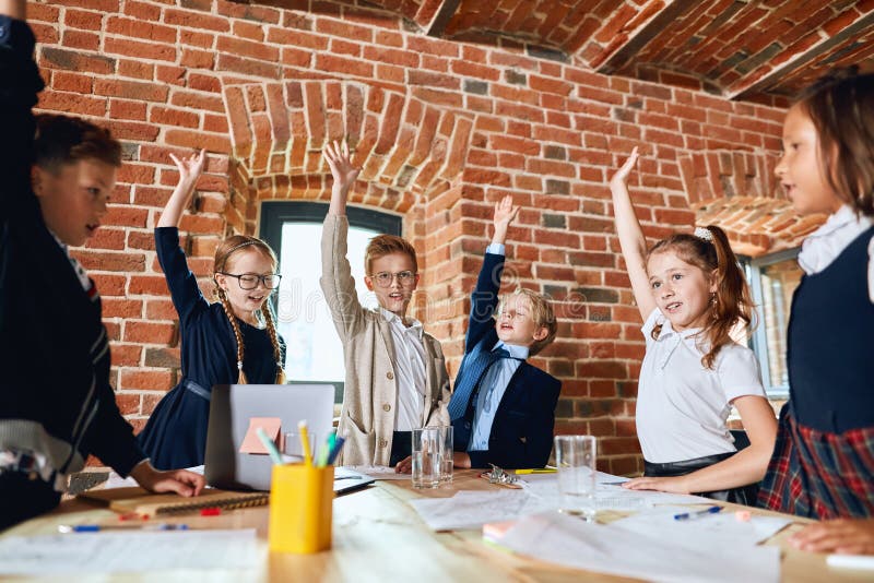 Cheerful happy kids with raised arms expressing their agreement in the lift room. close up photo