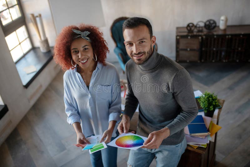 Cheerful interior designers feeling inspired for project stock photo