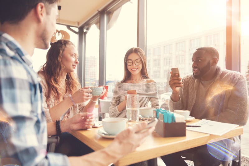 Cheerful international students resting in the cafe royalty free stock image Cheerful international students resting in the cafe royalty free stock image