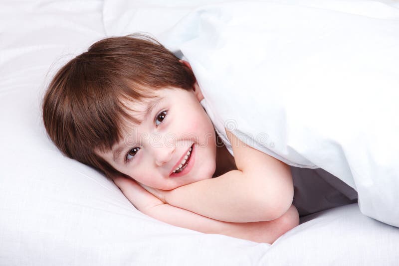 Cheerful kid in bed