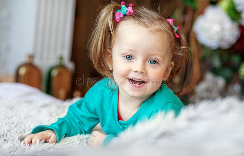 Cheerful little baby playing in the room. 2-3 years. The concept royalty free stock photo Cheerful little baby playing in the room. 2-3 years. The concept royalty free stock photo