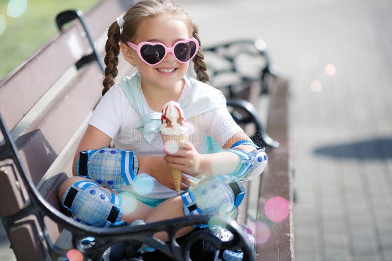 Cheerful little girl in the Park with ice cream cone