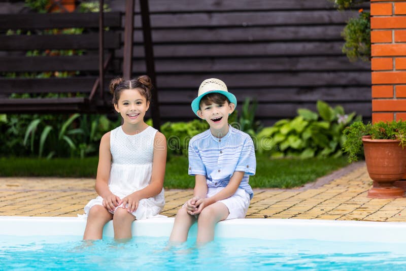 cheerful little siblings resting near swimming pool stock image cheerful little siblings resting near swimming pool stock image